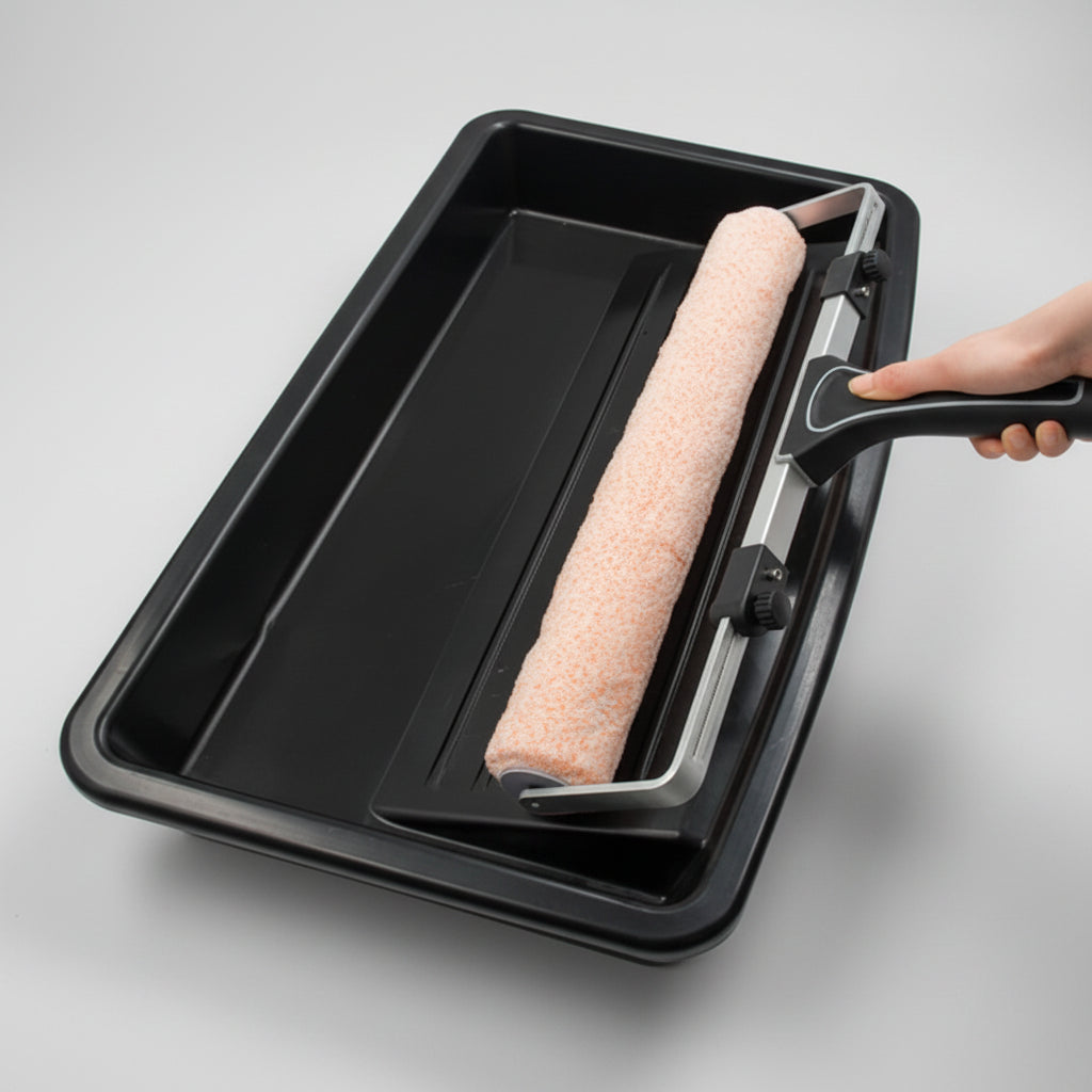 Paint roller with black tray on a white background