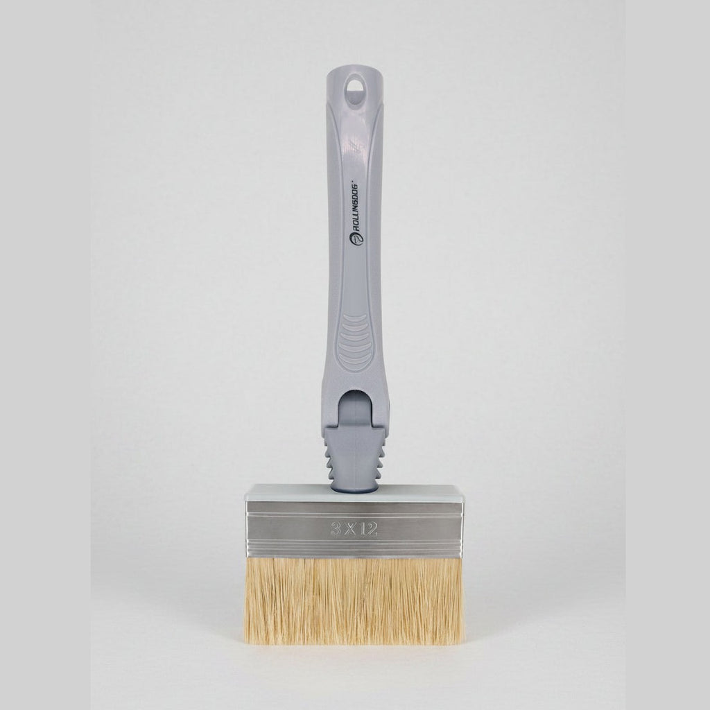 Paint brush with a gray handle and beige bristles on a white background
