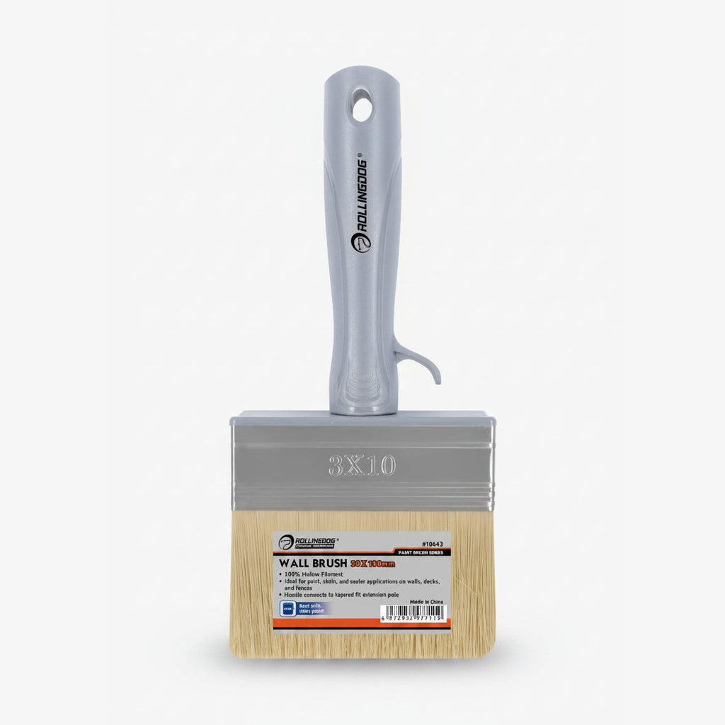 Wall brush with wooden handle and metal ferrule on a white background
